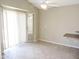 Bright living room features tile floors, a ceiling fan, and sliding glass door to the backyard at 6436 W Saddlehorn Rd, Phoenix, AZ 85083