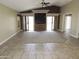 Large living room with neutral walls, tile flooring, and sliding glass doors for ample natural light at 6436 W Saddlehorn Rd, Phoenix, AZ 85083