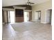 Spacious living room featuring a ceiling fan, built-in shelving, and sliding glass doors at 6436 W Saddlehorn Rd, Phoenix, AZ 85083