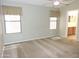 Main bedroom with carpet flooring, ceiling fan, and natural light from two large windows at 6436 W Saddlehorn Rd, Phoenix, AZ 85083