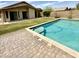 Backyard featuring a private swimming pool with a brick patio, ideal for outdoor entertainment and relaxation at 6436 W Saddlehorn Rd, Phoenix, AZ 85083