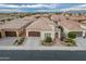 Aerial view of a well-maintained home with a tile roof, three-car garage, and manicured landscaping at 70 E Kennedia Dr, Queen Creek, AZ 85140