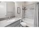 Well-lit bathroom featuring gray vanity, neutral paint, and tub with tiled wall at 70 E Kennedia Dr, Queen Creek, AZ 85140