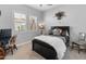 Charming bedroom with plantation shutters, a black bed frame, and whimsical decor at 70 E Kennedia Dr, Queen Creek, AZ 85140