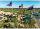 Picturesque community view featuring flags, serene ponds, palm trees and well-kept landscaping at 70 E Kennedia Dr, Queen Creek, AZ 85140