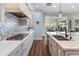 Contemporary kitchen featuring stainless appliances, cooktop, decorative tile backsplash, and ample counter space at 70 E Kennedia Dr, Queen Creek, AZ 85140