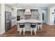 Bright kitchen showcasing gray cabinets, island with seating, stainless fridge, and modern backsplash at 70 E Kennedia Dr, Queen Creek, AZ 85140