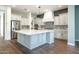 Open-concept kitchen with a large center island, stainless steel appliances, and modern finishes at 70 E Kennedia Dr, Queen Creek, AZ 85140