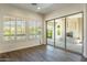 Living room with sliding glass doors to an outdoor fireplace and plantation shutters at 70 E Kennedia Dr, Queen Creek, AZ 85140