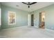 Spacious main bedroom featuring neutral carpeting, shutters, and an en-suite bathroom at 70 E Kennedia Dr, Queen Creek, AZ 85140