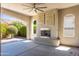 Covered patio with a fireplace, ceiling fan, and charming design elements at 70 E Kennedia Dr, Queen Creek, AZ 85140