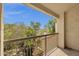 This balcony overlooks mature trees and landscaping with a blue sky above at 7101 W Beardsley Rd # 1502, Glendale, AZ 85308