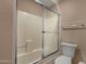 Bathroom featuring a bathtub, shower with glass doors, and a toilet at 7101 W Beardsley Rd # 1502, Glendale, AZ 85308
