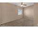 A carpeted bedroom featuring a ceiling fan and a window at 7101 W Beardsley Rd # 1502, Glendale, AZ 85308