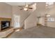 Open-concept living area with a fireplace, staircase, and stylish built-in shelves for storage and decor at 7101 W Beardsley Rd # 1502, Glendale, AZ 85308