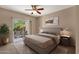 Comfortable main bedroom with a king bed, access to a private patio, and relaxing decor at 7101 W Beardsley Rd # 1502, Glendale, AZ 85308