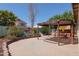 Relaxing backyard oasis featuring a hammock under a pergola and a colorful mural on the wall at 725 W Beth Dr, Phoenix, AZ 85041