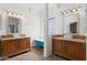 Charming bathroom with a clawfoot tub, and sinks, and decorative mirrors at 725 W Beth Dr, Phoenix, AZ 85041