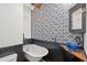 Unique bathroom features include stylish wallpaper, claw foot tub and blue glass vessel sink at 725 W Beth Dr, Phoenix, AZ 85041
