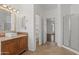 Bright bathroom showcasing vanity sink, glass shower, and an open doorway to the hallway at 725 W Beth Dr, Phoenix, AZ 85041