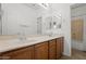 Well-lit bathroom featuring a double sink vanity, a large mirror, and a shower-tub combination at 725 W Beth Dr, Phoenix, AZ 85041