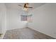 Bright bedroom features wood-look flooring, ceiling fan, and arched window with wood-look blinds at 725 W Beth Dr, Phoenix, AZ 85041