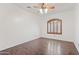 Bedroom featuring beautiful wood floors, a ceiling fan, and a window with wood shutters at 725 W Beth Dr, Phoenix, AZ 85041
