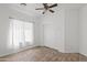 Bright bedroom with a ceiling fan, a window with lots of natural light, and sliding closet doors at 725 W Beth Dr, Phoenix, AZ 85041