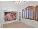 Charming bedroom with a unique world map feature wall and cozy window seat with shuttered windows at 725 W Beth Dr, Phoenix, AZ 85041