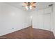Bedroom with wood floors, ceiling fan, closet and convenient built-in storage at 725 W Beth Dr, Phoenix, AZ 85041