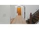 Hallway featuring tile floors leading to the front door and staircase to the second floor at 725 W Beth Dr, Phoenix, AZ 85041