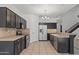 Updated kitchen features stainless steel appliances, an island, and ample counter space at 725 W Beth Dr, Phoenix, AZ 85041