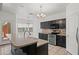 Gourmet kitchen with black cabinets, stainless steel appliances, and an island with sink at 725 W Beth Dr, Phoenix, AZ 85041