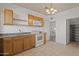 Functional kitchen with oak cabinetry, updated appliances, and convenient pantry access at 725 W Beth Dr, Phoenix, AZ 85041