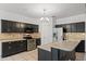 Well-equipped kitchen featuring sleek appliances, granite countertops, and an island at 725 W Beth Dr, Phoenix, AZ 85041