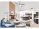 Bright living room featuring a fireplace, blue sofa, and view of the open-plan kitchen at 725 W Beth Dr, Phoenix, AZ 85041