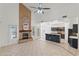 Open-concept living room with fireplace flowing into the kitchen with high ceilings at 725 W Beth Dr, Phoenix, AZ 85041