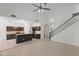 Spacious living room adjacent to the kitchen featuring a staircase to the second level at 725 W Beth Dr, Phoenix, AZ 85041