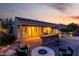 A beautiful backyard with an outdoor kitchen, covered patio, firepit, and seating offer luxurious desert living at 816 W Sycamore Ct, Litchfield Park, AZ 85340