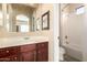 Bright bathroom with wood vanity and a separate shower/tub combo with a toilet at 816 W Sycamore Ct, Litchfield Park, AZ 85340