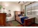 Cozy bedroom with hardwood floors, soft lighting, and a guitar on the wall at 816 W Sycamore Ct, Litchfield Park, AZ 85340