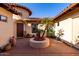Charming courtyard features lush plants, a circular planter with flowers, and a private entryway at 816 W Sycamore Ct, Litchfield Park, AZ 85340