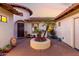 Picturesque courtyard with a round planter, lush palm trees, and a custom door entry, creating an inviting space at 816 W Sycamore Ct, Litchfield Park, AZ 85340
