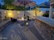 Outdoor retreat with a fire pit, stone accents, and ambient lighting, creating a warm atmosphere at 816 W Sycamore Ct, Litchfield Park, AZ 85340