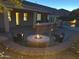 Inviting backyard featuring a stone fire pit, bar, and patio with ample seating for entertainment at 816 W Sycamore Ct, Litchfield Park, AZ 85340