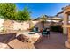 A beautiful patio area with a firepit and lemon tree provides a serene space to unwind and relax at 816 W Sycamore Ct, Litchfield Park, AZ 85340