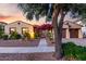 Charming single-story home with a desert landscaped front yard and vibrant bougainvillea over the gated entry at 816 W Sycamore Ct, Litchfield Park, AZ 85340