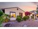 Inviting front yard with desert landscaping and colorful plants accentuating the facade of this home at 816 W Sycamore Ct, Litchfield Park, AZ 85340
