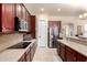 Bright kitchen with stainless appliances, dark wood cabinets and ample counter space for the home chef at 816 W Sycamore Ct, Litchfield Park, AZ 85340