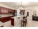 Well-equipped kitchen with wood cabinetry, breakfast bar, and modern appliances for meal preparation at 816 W Sycamore Ct, Litchfield Park, AZ 85340